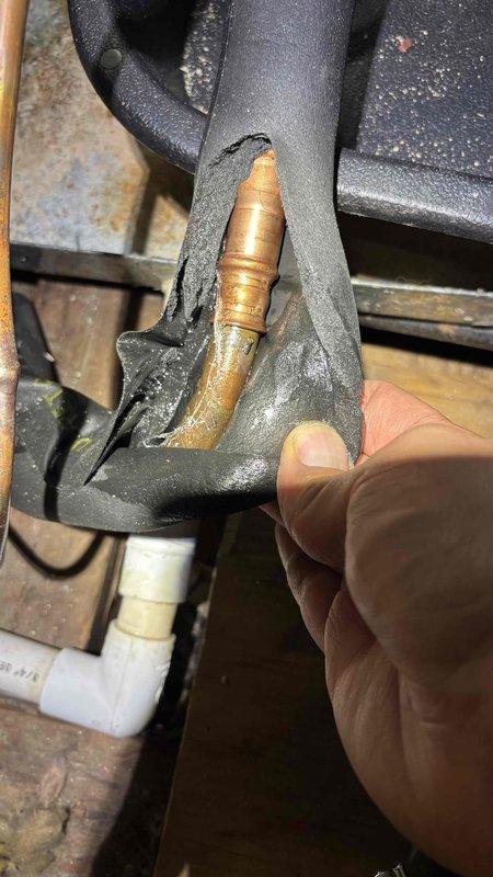 Responded to no-cool call on recently installed system. Upon arrival, found unit not powering on and confirmed previous drain line clog had been addressed. Inspected attic-mounted air handler and discovered damaged refrigerant line insulation exposing copper tubing, which was compromising system efficiency and potentially causing low voltage issues from exposed conductors near deteriorated foam. Replaced damaged insulation sections on refrigerant lines and verified all electrical connections were secure and free from moisture intrusion. System restored to proper operation with adequate airflow and cooling capacity confirmed.