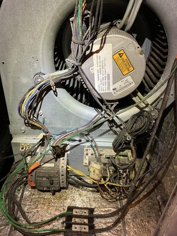 Completed first prepaid cooling system maintenance visit. Upon arrival, addressed customer concern regarding a broken handle from previous service visit that was never repaired or replaced. Performed comprehensive inspection of air handler unit, examining blower motor assembly, electrical connections, and wiring harness. All wire bundles were properly secured with zip ties and connections were verified at terminal blocks. Inspected motor housing, fan blades, and internal components for proper operation. 

During exterior unit inspection, discovered severe heat damage to refrigerant line service valve assembly. The valve housing showed extensive thermal stress with metal casing ruptured, peeled back, and melted, exposing internal brass fittings. Black insulated refrigerant lines and foam insulation exhibited signs of extreme heat exposure. This damage indicates a critical failure that occurred during previous operation or service work, rendering the affected component non-functional and