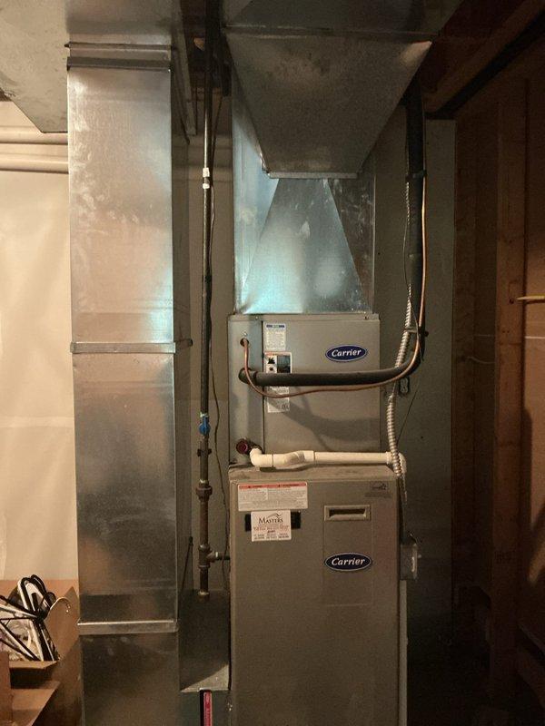 Provided estimate for replacement of 2006 Carrier gas furnace following basement flooding caused by sump pump failure. Water intrusion resulted in blower circulating water throughout the system, and inducer motor exhibited excessive noise independent of water damage. Unit currently operational but replacement recommended due to age and water exposure compromising long-term reliability.