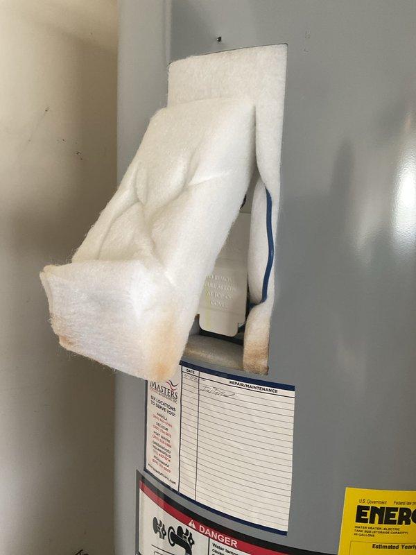 Responded to service call for tanked water heater with reported brown discoloration near temperature-pressure relief valve and inconsistent water temperature issues. Upon inspection, evaluated the TP valve assembly and surrounding connections for signs of mineral deposits, corrosion, or discharge. Assessed water heater operation and temperature settings to address concerns regarding excessively hot water conditions versus inadequate hot water delivery during use. Documented equipment condition through photographic records showing TP valve configuration, brass relief valve assembly with copper discharge piping, maintenance tracking labels, and overall unit status. Verified proper valve function and examined potential causes of temperature inconsistencies affecting household hot water supply.