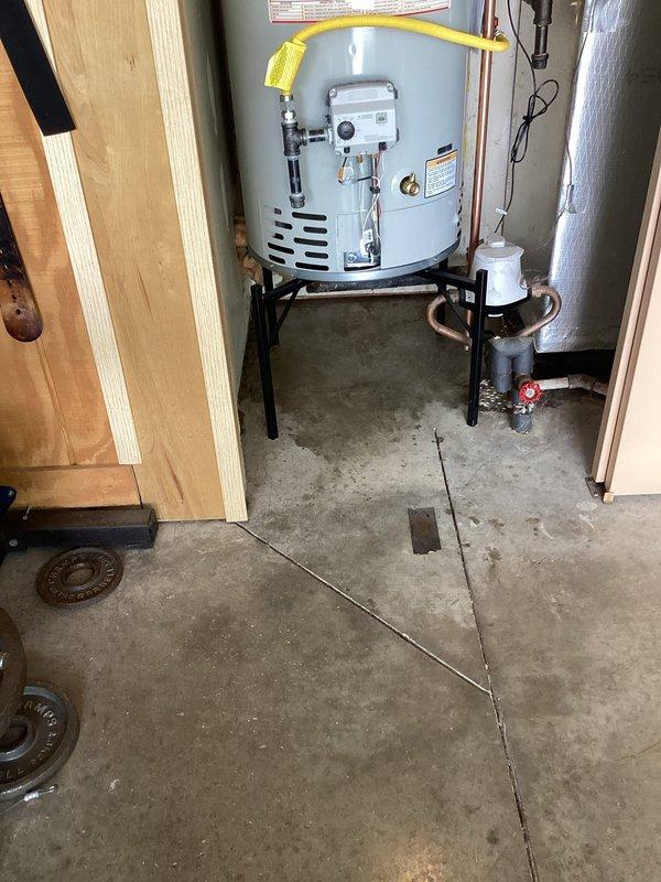 Removed existing water heater and installed new 40-gallon natural gas water heater on elevated stand in basement utility area. Connected copper water supply lines with proper shutoff valves, installed flexible yellow gas line to unit, and configured venting system with metallic ductwork. Verified all connections for proper operation, tested gas valve and thermostat controls, and ensured compliance with manufacturer specifications and local plumbing codes.