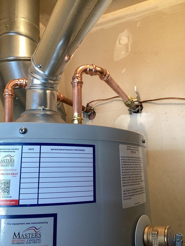 Removed existing water heater and installed new 40-gallon natural gas water heater on elevated stand in basement utility area. Connected copper water supply lines with proper shutoff valves, installed flexible yellow gas line to unit, and configured venting system with metallic ductwork. Verified all connections for proper operation, tested gas valve and thermostat controls, and ensured compliance with manufacturer specifications and local plumbing codes.