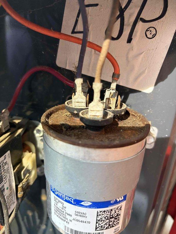 Completed comprehensive AC tune-up on residential cooling system. Upon inspection, discovered capacitor with severe rust deterioration on metal cap and corrosion buildup around terminal connections, though unit remained functional. Performed standard maintenance protocol including system performance testing, electrical measurements showing 95.05 voltage reading and 0.00 amp draw at time of testing, cleaned condenser coil, checked refrigerant levels, and verified proper system operation. System restored to optimal working condition with recommendations provided for future capacitor replacement due to advanced corrosion.