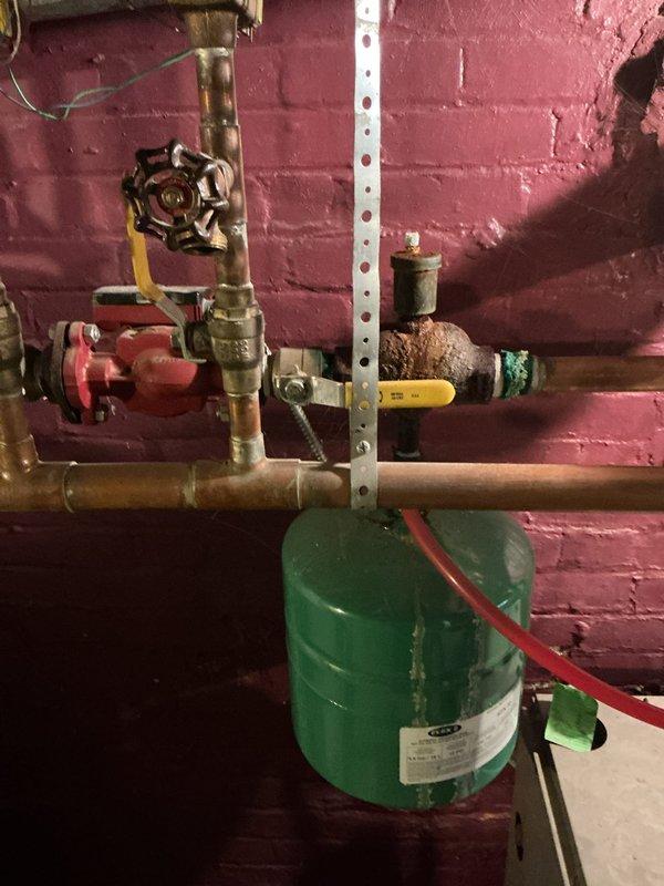 Responded to referral request to remove and cap three boiler heating registers to facilitate drywall installation and restoration work. Successfully disconnected register piping from main boiler distribution lines, cut copper supply lines at appropriate locations, and installed brass cap fittings on all three branch lines to seal the system. Tested capped connections for leaks and verified system pressure remained stable after modifications. Work area included basement mechanical room with existing expansion tank and valve assembly, as well as crawlspace access points where register lines were terminated. All piping modifications completed to code, allowing restoration contractor to proceed with wall finishing work while maintaining integrity of remaining boiler heating system.