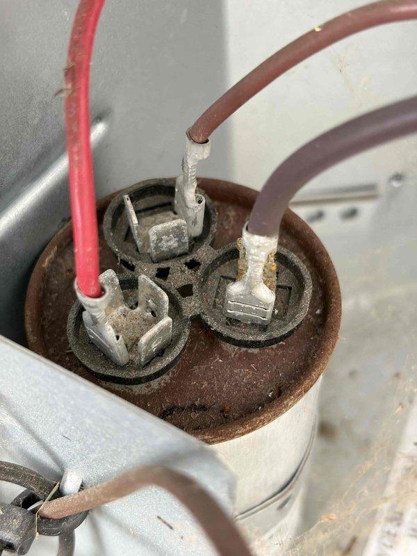 Completed comprehensive air conditioning tune-up and system evaluation. Inspected electrical components including capacitor and terminal connections, noting visible oxidation and corrosion on terminal block requiring monitoring for future replacement. Performed electrical diagnostics using digital multimeter to verify proper voltage, amperage, and system performance parameters, confirming unit operating within manufacturer specifications.