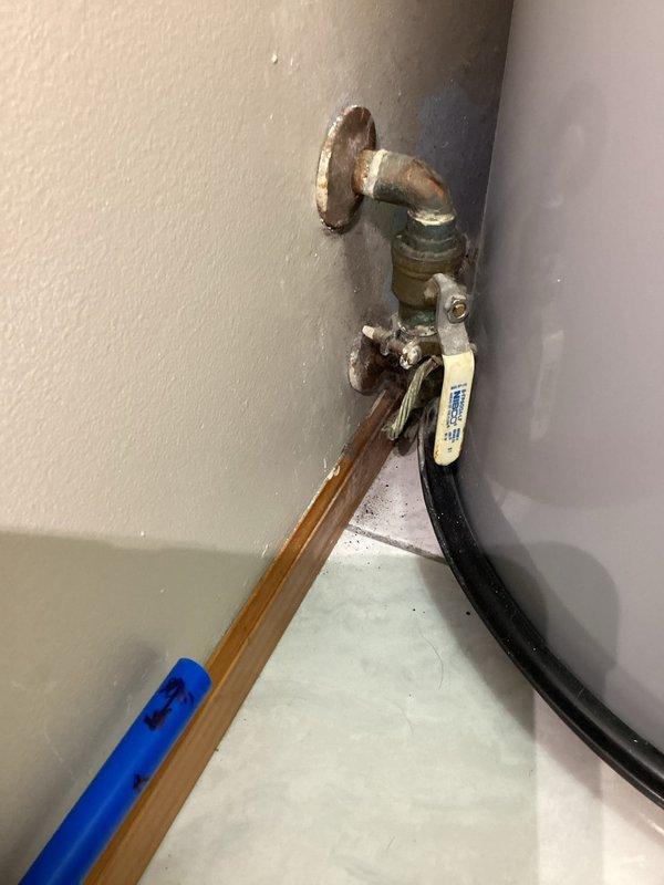 Provided plumbing estimate for connecting customer-installed Whirlpool water softener and water heater on main floor. Assessed existing water heater installation with copper supply lines, brass shut-off valves, pressure relief piping, and flexible hose connections. Evaluated plumbing configuration requirements to integrate water softener system with existing water heater hookup, including necessary valve installations, supply line connections, and proper sequencing of water treatment equipment.