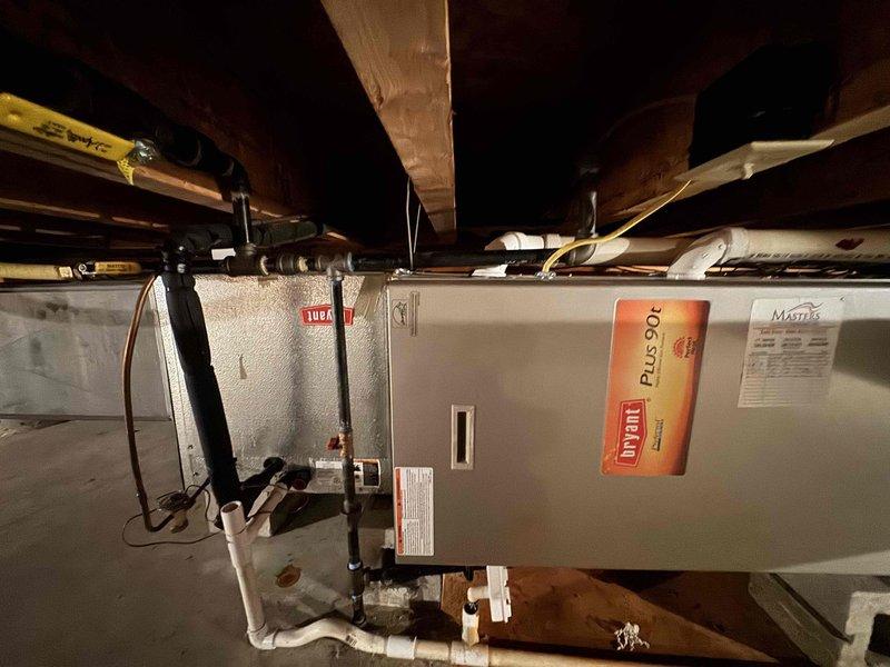 Responded to no heat call on Bryant Plus 90 gas furnace located in crawlspace. Upon arrival, found thermostat blank with no power. Traced issue to tripped circuit breaker or blown fuse at electrical panel. Reset breaker, restored power to thermostat and furnace. Verified thermostat display operational and system responding to temperature calls. Cycled furnace through complete heating cycle, confirmed ignition sequence, burner operation, and proper airflow. All safety controls functioning within normal parameters. System restored to full operation.