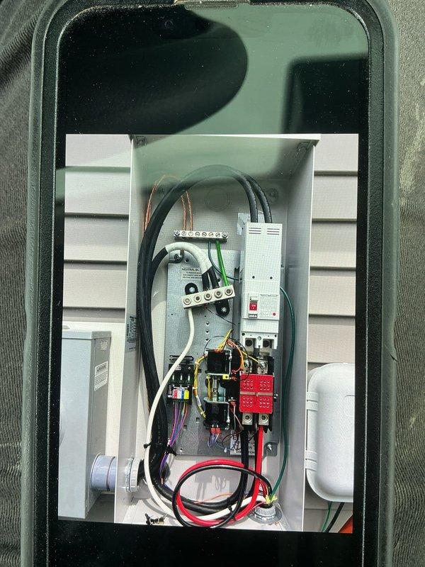 Completed installation of 10kW Generac standby generator system with full electrical integration. Mounted and wired transfer switch enclosure on exterior wall, establishing proper connections between utility service, generator, and home electrical panel. Installed all required circuit breakers, terminal blocks, and safety disconnects per manufacturer specifications and local electrical code. Ran and terminated all power conductors, including line, load, and neutral wiring with appropriate gauge copper wire. Performed voltage testing and verification, confirming proper 120V readings across circuits to ensure safe and reliable automatic transfer switch operation during power outages.