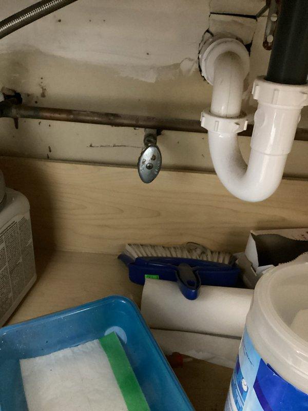 Responded to emergency call for bathroom faucet that would not shut off. Upon arrival, found that the shut-off valve at the base of the sink had broken during customer's attempt to stop water flow, resulting in active water leak. Successfully shut off water supply to the affected fixture to stop the leak. Assessed the damaged shut-off valve and surrounding plumbing connections under the sink. Documented existing conditions including P-trap assembly, supply line connections, and cabinet interior for repair planning. Secured the area and ensured no further water damage would occur.