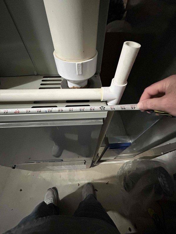 Responded to a tech lead request for counter sales consultation. Conducted site assessment of residential HVAC system, documenting exterior air conditioning unit installation with electrical disconnect and conduit routing on vinyl-sided structure. Performed interior evaluation of basement mechanical room, measuring existing white PVC drainage piping configuration connected to HVAC condensate system to provide accurate specifications for required materials or replacement components.