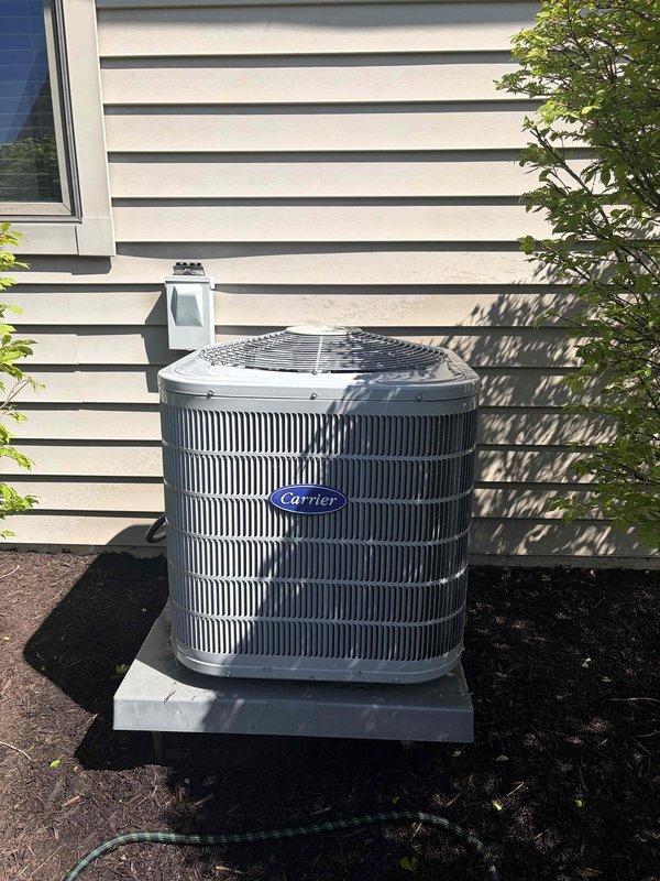 Completed seasonal cooling maintenance on Carrier outdoor condensing unit as part of prepaid maintenance agreement. Performed comprehensive system inspection, verified electrical connections at disconnect box, tested system operation with digital multimeter readings confirming proper amperage draw and capacitor values within manufacturer specifications, and documented equipment condition with photos showing unit properly positioned on concrete pad with adequate clearance from surrounding vegetation.