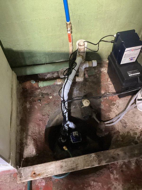 Completed installation of backup battery system for existing sump pump assembly in basement utility area. Installed battery backup control unit with electrical connections to ensure continued pump operation during power outages. Verified proper integration with primary sump pump system, tested battery charging functionality, and confirmed automatic switchover capability. All electrical connections secured per code requirements, and system operational testing confirmed successful backup power engagement.