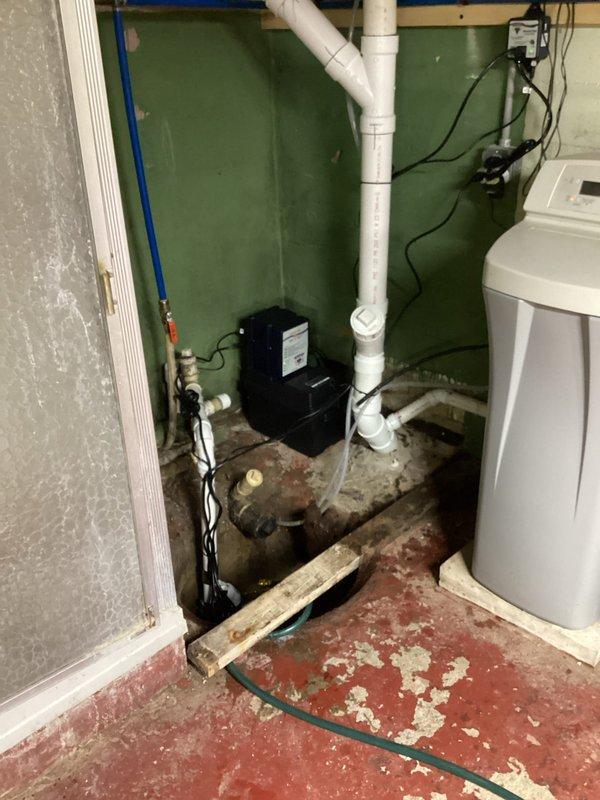 Completed installation of backup battery system for existing sump pump assembly in basement utility area. Installed battery backup control unit with electrical connections to ensure continued pump operation during power outages. Verified proper integration with primary sump pump system, tested battery charging functionality, and confirmed automatic switchover capability. All electrical connections secured per code requirements, and system operational testing confirmed successful backup power engagement.