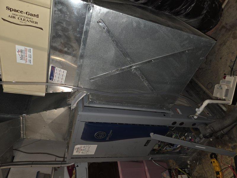 Responded to no cooling complaint on geothermal system with indoor temperature at 77°F and not dropping. Upon inspection, discovered severely clogged air filter with excessive dust and debris accumulation, restricting airflow through the air handler. Replaced dirty filter and verified system operation. Unit now cooling properly with adequate airflow restored through ductwork and Space-Gard air cleaner assembly.