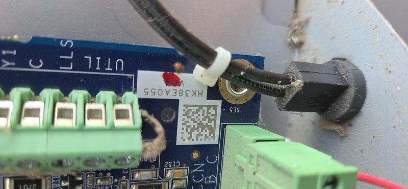 Responded to service call for heat pump outdoor temperature sensor (OST) thermistor issue. Accessed control board assembly and inspected electronic components, wiring connections, and terminal blocks. Documented internal configuration of circuit board including sensor connections and wiring harness. Verified proper connections at green terminal blocks and examined circuit board for any visible damage or loose connections. Photographed control board assembly and sensor wiring for service records.