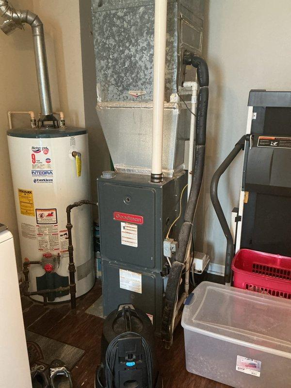 Conducted on-site evaluation of existing HVAC system in residential utility room for complete furnace and air conditioning replacement estimate. Assessed current equipment including aging furnace unit with visible wear, dust accumulation, and operational degradation, along with existing ductwork configuration and water heater placement. Documented equipment specifications, measured clearances, photographed existing installation including furnace nameplate data and spatial constraints, and evaluated electrical service, gas line connections, and ventilation requirements to provide comprehensive replacement system recommendations.