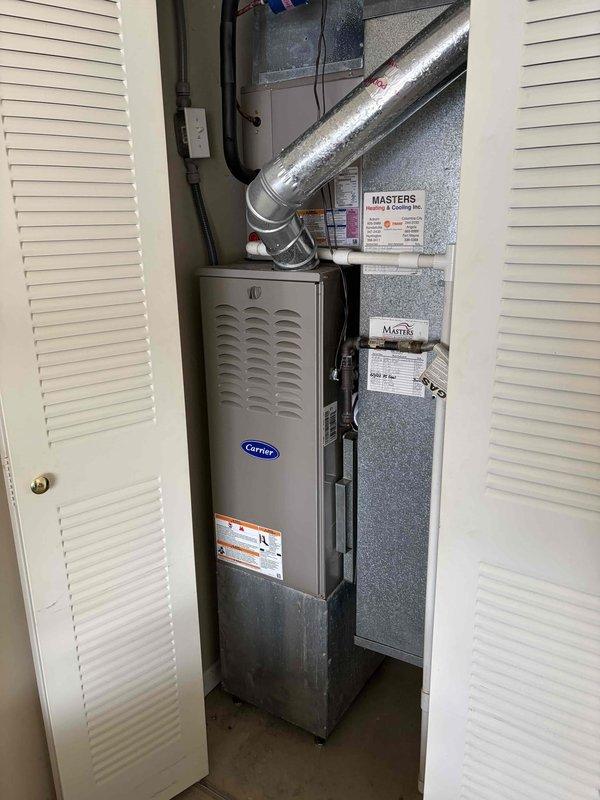 Completed comprehensive AC tune-up on residential Carrier HVAC system located in utility closet. Performed standard maintenance inspection of air handler unit, verified proper operation of all system components, and replaced air filter with new Filtrete pleated filter marked for future reference. System operating within normal parameters with no issues identified at time of service.