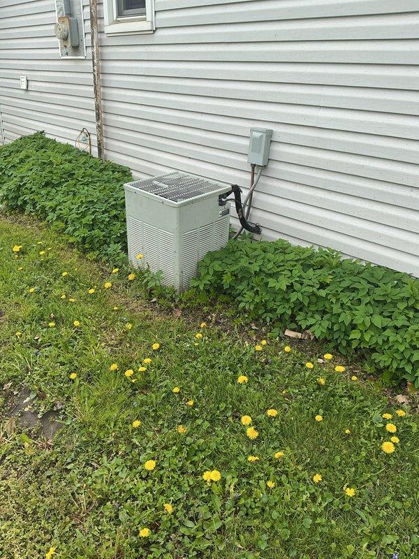 Conducted comprehensive site assessment for complete HVAC system replacement at residential property. Evaluated existing outdoor condensing unit and indoor equipment installation area, taking measurements of mounting locations and clearances in basement utility space. Photographed current equipment configuration including exterior AC unit with refrigerant lines and electrical disconnect, as well as indoor mounting brackets and structural components. Discussed replacement options for air conditioning system and potential furnace replacement, with financing considerations presented for complete system upgrade.