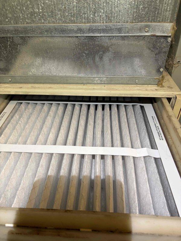 Responded to no cooling complaint on 14-15 year old air conditioning system. Upon arrival, verified minimal cooling output and inspected system components. Found heavily soiled air filter restricting airflow, which was contributing to reduced cooling performance. Removed and replaced dirty pleated air filter with proper-sized filter. System airflow improved significantly after filter replacement. Advised customer that aging system components may require additional service in the future given the unit's age and current performance issues.