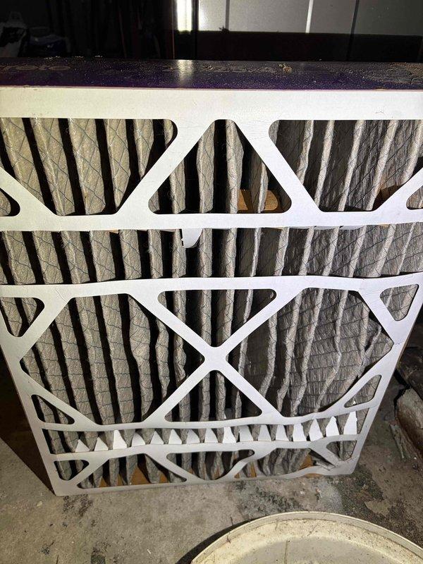 Responded to no cooling complaint on 14-15 year old air conditioning system. Upon arrival, verified minimal cooling output and inspected system components. Found heavily soiled air filter restricting airflow, which was contributing to reduced cooling performance. Removed and replaced dirty pleated air filter with proper-sized filter. System airflow improved significantly after filter replacement. Advised customer that aging system components may require additional service in the future given the unit's age and current performance issues.