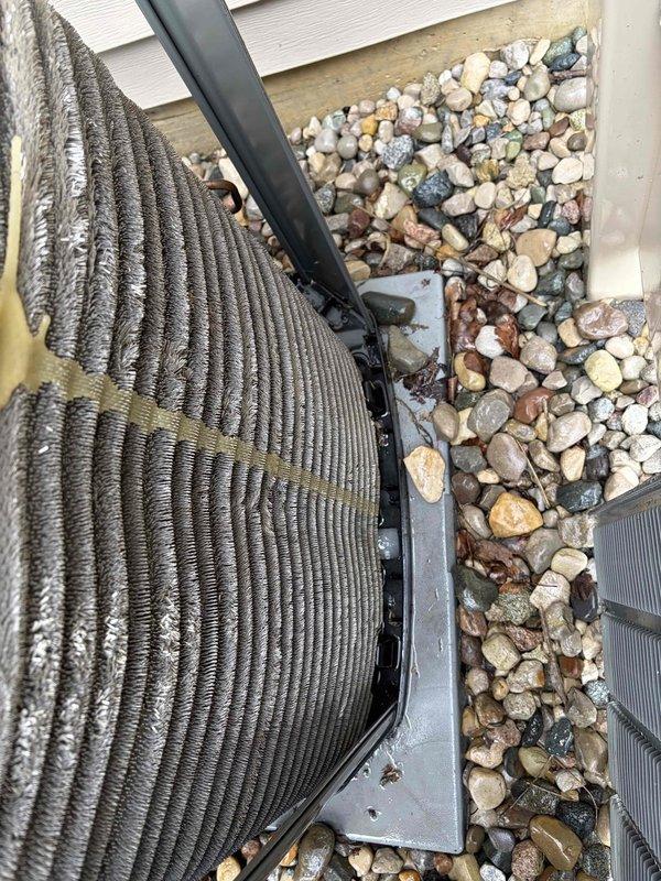 Completed comprehensive air conditioning tune-up and cleaning service on outdoor condensing unit. Coil surfaces showed heavy accumulation of dust, dirt, and debris with visible organic growth and oxidation on aluminum fins. Thoroughly cleaned heat exchanger coils, removed environmental buildup from cooling fins, and inspected copper refrigerant lines and mounting brackets. Unit restored to optimal operating condition for efficient seasonal performance.
