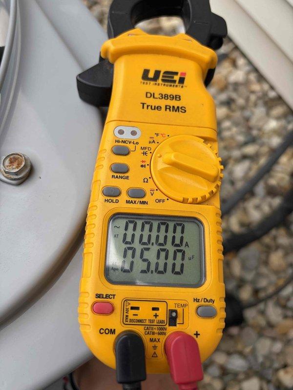 Performed routine maintenance inspection on residential cooling system. Used clamp meter to verify electrical readings, measuring current draw at 00.00A and capacitance at 344µF on outdoor unit components. Additionally measured resistance at 24.00Ω and confirmed system voltage at 25.90V to ensure proper operation. All electrical parameters were within manufacturer specifications, and unit is operating normally for the cooling season.