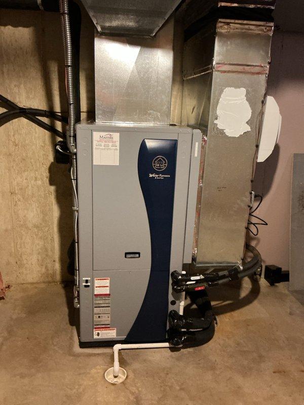 Completed full installation of WaterFurnace 5 Series geothermal heat pump system in basement mechanical room. Installed WaterFurnace W5AV048bd1A12CTR2B01 4-ton unit featuring 2-stage compressor, variable speed blower motor, integrated desuperheater for domestic water heating assistance, and Cupronickel water coil for enhanced corrosion resistance. Unit equipped with IntelliStart technology to reduce startup current by 60%, minimizing electrical demand, light flicker, and compressor wear during operation cycles.

Mounted and connected WaterFurnace EAL15B 15kW auxiliary electric heater to provide supplemental heating capacity during extreme cold conditions or high demand periods. Installed WaterFurnace Flow Center Connector Kit and integrated two Grundfos circulation pumps to maintain proper ground loop flow rates and system efficiency. All ground loop connections secured and pressure tested to ensure leak-free operation.

Installed WaterFurnace TPCM32U04A communicating thermostat with i