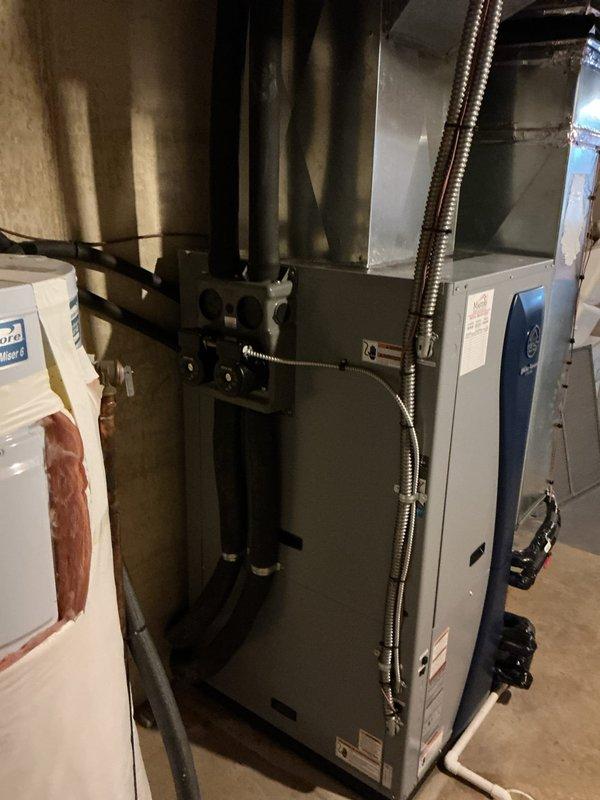 Completed full installation of WaterFurnace 5 Series geothermal heat pump system in basement mechanical room. Installed WaterFurnace W5AV048bd1A12CTR2B01 4-ton unit featuring 2-stage compressor, variable speed blower motor, integrated desuperheater for domestic water heating assistance, and Cupronickel water coil for enhanced corrosion resistance. Unit equipped with IntelliStart technology to reduce startup current by 60%, minimizing electrical demand, light flicker, and compressor wear during operation cycles.

Mounted and connected WaterFurnace EAL15B 15kW auxiliary electric heater to provide supplemental heating capacity during extreme cold conditions or high demand periods. Installed WaterFurnace Flow Center Connector Kit and integrated two Grundfos circulation pumps to maintain proper ground loop flow rates and system efficiency. All ground loop connections secured and pressure tested to ensure leak-free operation.

Installed WaterFurnace TPCM32U04A communicating thermostat with i