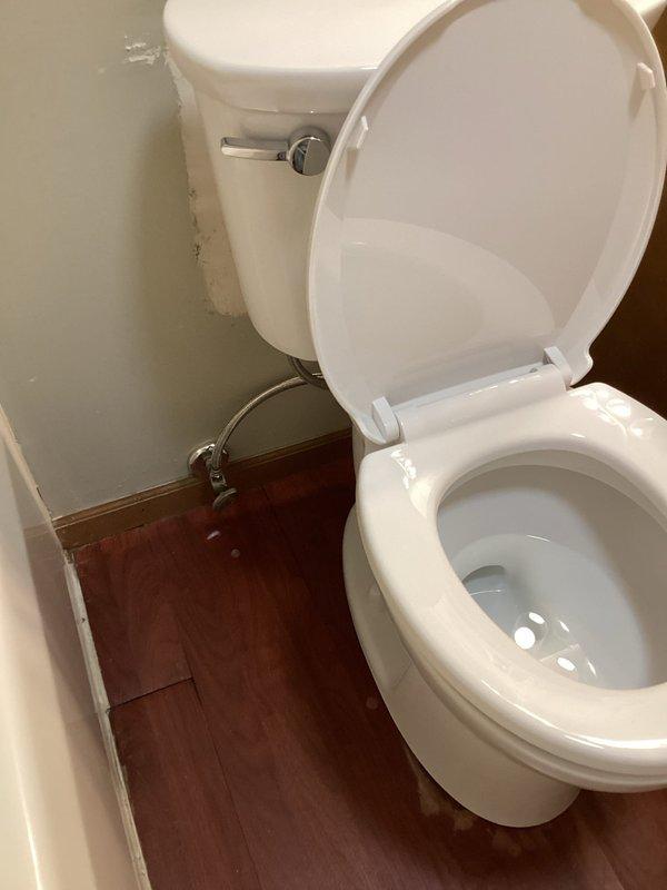Removed existing toilet and installed new white porcelain toilet in residential bathroom. Secured unit to floor flange with new wax ring seal and closet bolts, reconnected water supply line, and tested for proper operation and leaks. Verified flush mechanism functioned correctly and left work area clean with all fixtures operational.