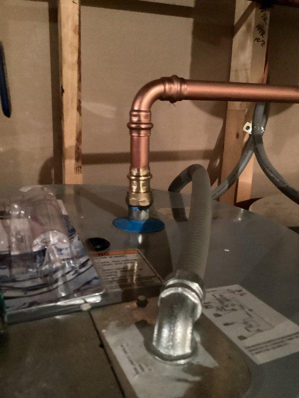 Completed electric tanked water heater installation in residential utility area with two-person crew over three-hour period. Installed new stainless steel water heater tank with copper supply piping, brass compression fittings, and shutoff valves. Connected all necessary plumbing lines including hot and cold water supply connections with proper elbow joints and horizontal runs. Integrated system with existing blue pressure expansion tank and ensured proper electrical connections. All copper piping secured to wall framing with appropriate supports, and installation meets code requirements for residential water heating systems.