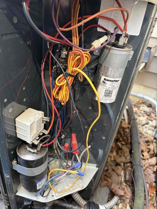 Completed first prepaid cooling season maintenance visit on residential HVAC system. Performed comprehensive inspection of outdoor condensing unit, accessing internal components to verify proper operation of capacitor, compressor, electrical connections, and control relays. Measured system temperature at 79.8°F and confirmed all electrical components within normal operating parameters, with wiring harnesses and connections secure throughout the unit.