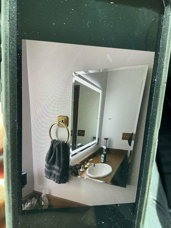 Installed new LED lighted mirror in bathroom and removed existing vanity light fixture. Installed medicine cabinet and completed associated electrical connections to ensure proper operation of all new fixtures.