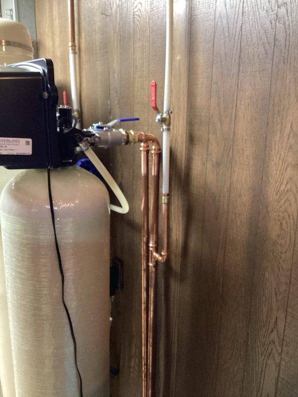 Installed and tied in new exterior hose bib to existing copper water supply line in utility room. Work included cutting into main water line, soldering new copper fittings and branch line, installing shut-off valve for hose bib control, and pressure testing all connections to ensure leak-free operation.