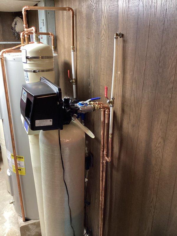 Installed and tied in new exterior hose bib to existing copper water supply line in utility room. Work included cutting into main water line, soldering new copper fittings and branch line, installing shut-off valve for hose bib control, and pressure testing all connections to ensure leak-free operation.