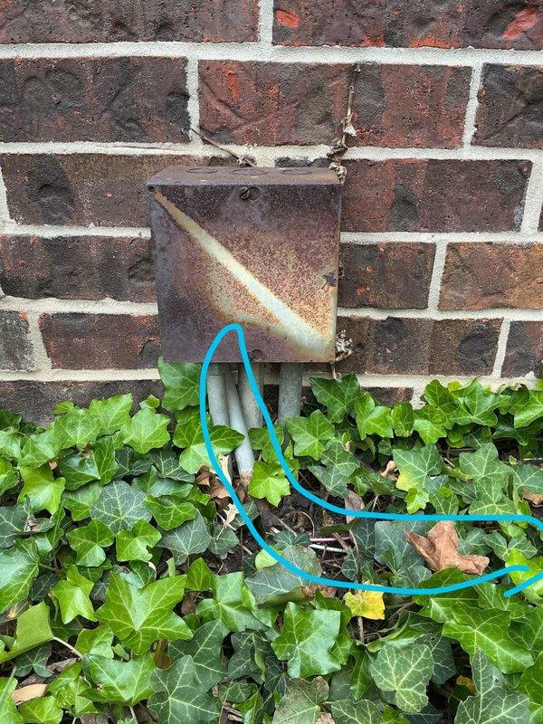 Responded to service call for removal of fence-mounted lighting fixtures. Upon arrival, assessed the installation which consisted of exterior lights mounted along a residential fence line with associated electrical wiring running through landscaped areas at the base of the brick structure. Disconnected electrical supply to the lighting circuit and verified power was de-energized before proceeding with removal work. Removed all fence-mounted light fixtures and associated mounting hardware from the brick wall. Extracted the bright blue-green electrical cable that was routed through the ivy bed and garden area along the foundation. Properly capped and secured all electrical connections per code requirements. Removed all mounting brackets and hardware, leaving the brick wall surface ready for any future installations or repairs as needed by the customer.