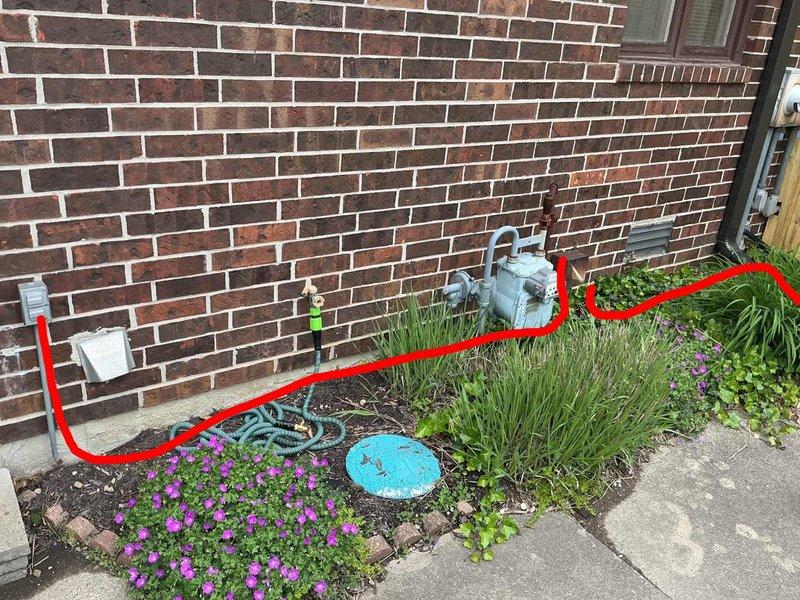 Responded to service call for removal of fence-mounted lighting fixtures. Upon arrival, assessed the installation which consisted of exterior lights mounted along a residential fence line with associated electrical wiring running through landscaped areas at the base of the brick structure. Disconnected electrical supply to the lighting circuit and verified power was de-energized before proceeding with removal work. Removed all fence-mounted light fixtures and associated mounting hardware from the brick wall. Extracted the bright blue-green electrical cable that was routed through the ivy bed and garden area along the foundation. Properly capped and secured all electrical connections per code requirements. Removed all mounting brackets and hardware, leaving the brick wall surface ready for any future installations or repairs as needed by the customer.