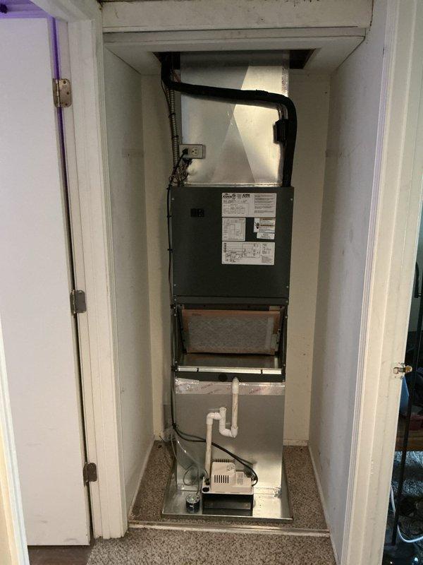 Completed installation of customer-supplied air handler and outdoor A/C unit in end closet location. Installed Goodman GN4SAN418-A air handler with matching condensate pump system and connected outdoor condensing unit, verified all electrical connections per manufacturer specifications at 208-230V, installed black flexible ductwork from air handler to ceiling plenum, and confirmed proper refrigerant line connections. Removed and transported old equipment to maintenance facility per property requirements.