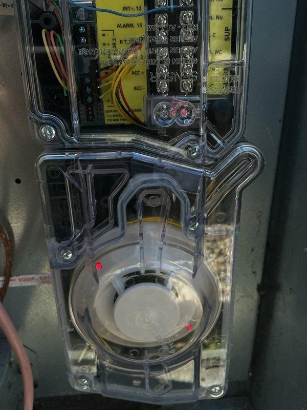 Installed two duct detectors in rooftop unit (RTU) electrical control panels to meet fire marshal compliance requirements. Connected detectors to existing alarm circuits with proper wiring terminations and verified operational functionality of both smoke detection devices upon completion.