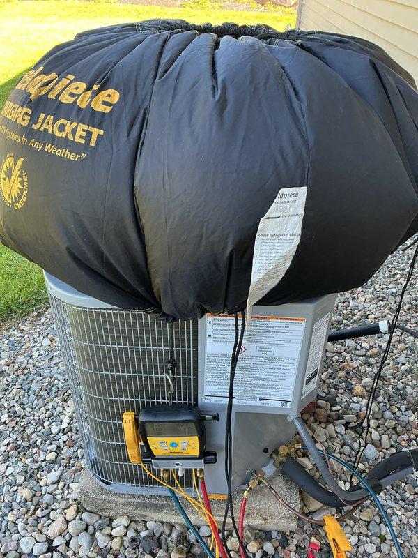 Performed AC start-up on recently installed outdoor condensing unit. Connected digital manifold gauges to service ports and verified system pressures, temperatures, and refrigerant charge levels were within manufacturer specifications. Applied protective spring jacket to unit and confirmed all safety labels and warning placards were properly affixed and legible.