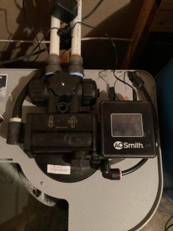 Completed installation of warranty replacement motor assembly on AO Smith water softener system. The original motor's gear drive had failed, causing the unit to remain stuck in fill position and preventing proper cycling back to home position. Replaced the defective motor assembly with customer-provided warranty part, reconnected all electrical connections and plumbing lines, and verified proper system operation through complete regeneration cycle. Unit now cycles correctly through all positions and returns to home position as designed.
