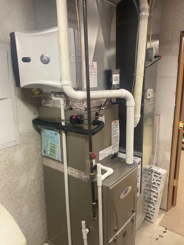 Completed full HVAC system replacement including installation of Carrier 26SCA436N003 Comfort Series single-stage air conditioner, Carrier CVAVA3617XMA evaporator coil, and Carrier 59TP7A080V17-16 Performance 97 Series two-stage gas furnace with 80,000 BTU input capacity. Removed and recycled existing equipment, then reconnected system to existing supply and return ductwork. Installed new 2-inch PVC condenser pad for outdoor unit placement, reconnected to existing refrigerant line set after flushing and pressure testing to verify system integrity. Installed new electrical disconnect and whip for outdoor unit, ensuring proper power supply and code compliance.

Mounted Honeywell T6 thermostat and programmed system settings for optimal two-stage furnace operation. Completed furnace changeout utilizing standard installation kit for 80% to 97% efficiency upgrade. Reconnected gas supply line with proper shut-off valves and tested for leaks. Installed and routed white PVC venting pipes for hi