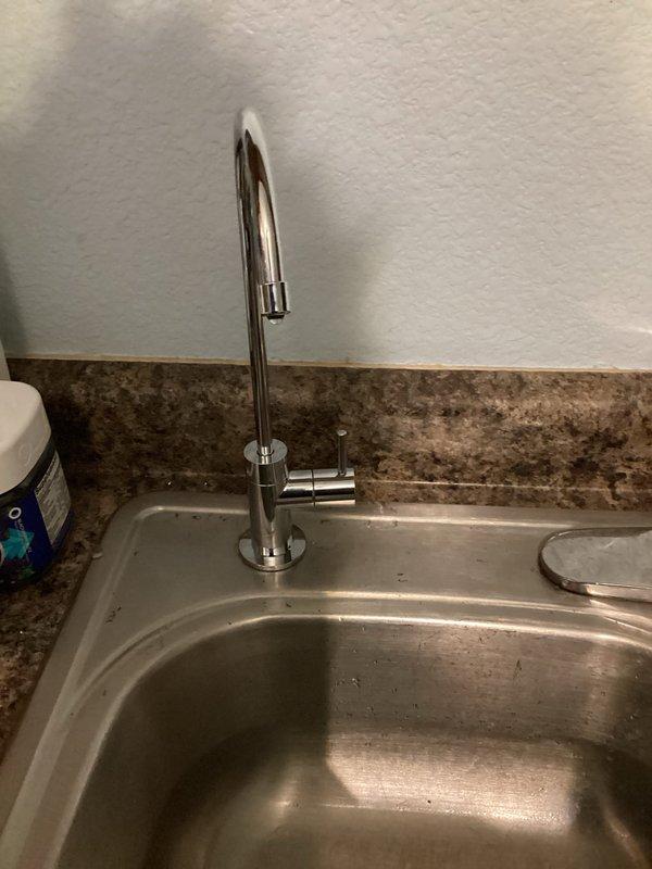 Completed installation of customer-provided reverse osmosis water filtration system under kitchen sink, including all necessary connections and supply lines. Replaced shut-off valve to washing machine with customer-provided valve. Installed new trap assembly to kitchen sink using customer-provided parts, ensuring proper drainage and seal connections.