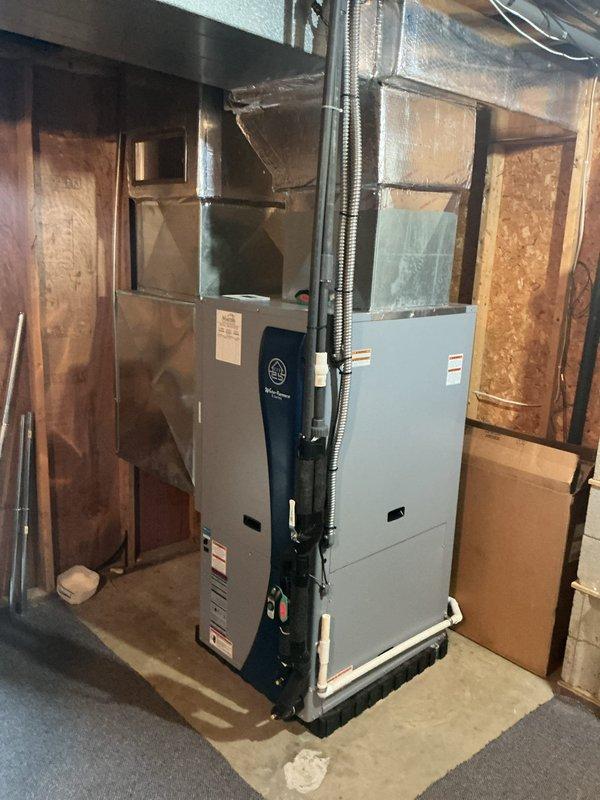 Completed full installation of WaterFurnace 5 Series geothermal heat pump system including model W5AV048BD1A02NTL2B01 4-ton unit with 2-stage compressor, variable speed blower motor, and Cupronickel water coil. Installed IntelliStart technology to reduce start current by 60% for improved compressor performance and reduced electrical demand. Integrated WaterFurnace TPCC32U03WWWAT communicating thermostat with energy monitoring and humidity control capabilities. Added WaterFurnace EAL20B 20kW auxiliary heater for supplemental heating capacity. Installed well water kit configured for 3-step compressor operation and flow center connector kit for proper system integration. Connected all electrical service per manufacturer specifications at 208-230V single phase, 60Hz with proper circuit protection. Mounted unit on concrete pad in basement mechanical room with ductwork connections to existing distribution system. Retained existing filter size for compatibility with current system configurati