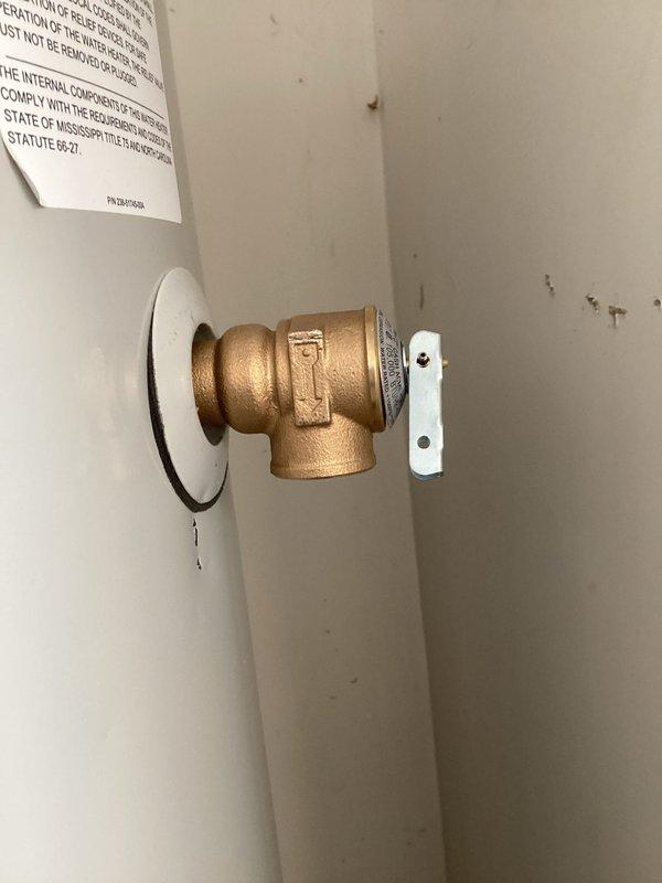 Responded to emergency call for water heater pipe leak that customer was unable to stop. Upon arrival, assessed the leaking brass valve assembly connected to the water heater system. Removed and replaced the defective T-shaped brass valve fitting with new component, ensuring proper alignment using level tool during installation. Verified all connections were secure, tested system for leaks, and confirmed proper operation of the shut-off valve. System restored to full functionality with no active leaks detected.