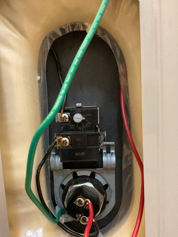 Responded to service call for insufficient hot water capacity on recently installed water heater. Upon inspection, diagnosed faulty upper thermostat causing inadequate water heating. Removed defective thermostat assembly through upper access port and replaced with new unit. Verified proper electrical connections at brass terminals, confirmed ground wire placement, and tested heating element continuity. Adjusted temperature settings on both upper and lower thermostats to manufacturer specifications. Cycled unit through complete heating cycle to ensure proper operation and adequate hot water recovery time.
