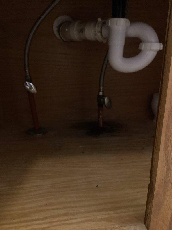 Responded to service request for bathroom plumbing fixture replacement. Successfully replaced two bathroom faucets with chrome fixtures featuring black handles, ensuring proper installation and water flow. Replaced existing drain pipes and P-trap assembly with new white PVC components, creating proper drainage configuration. Installed new braided stainless steel supply lines connected to angle stop shutoff valves for both hot and cold water feeds. Tested all connections for leaks, verified proper water pressure and drainage flow, and confirmed all plumbing components functioning correctly upon completion.