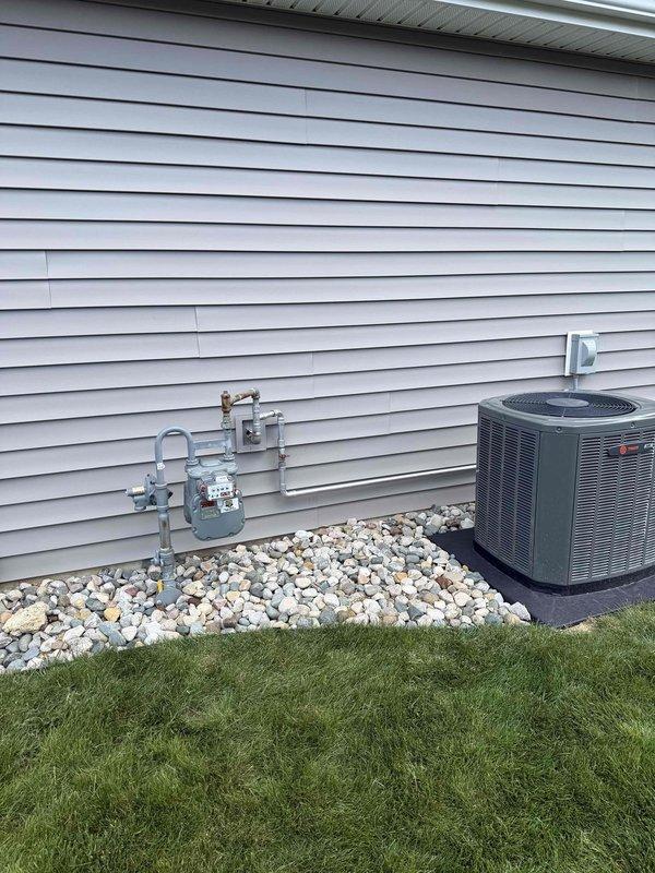 Installed natural gas supply line from existing gas meter to new standby generator unit. Routed black iron pipe along exterior wall of residence, secured with appropriate hangers and supports per code requirements. Connected gas line to generator inlet with approved fittings and performed pressure test to verify system integrity and leak-free operation.