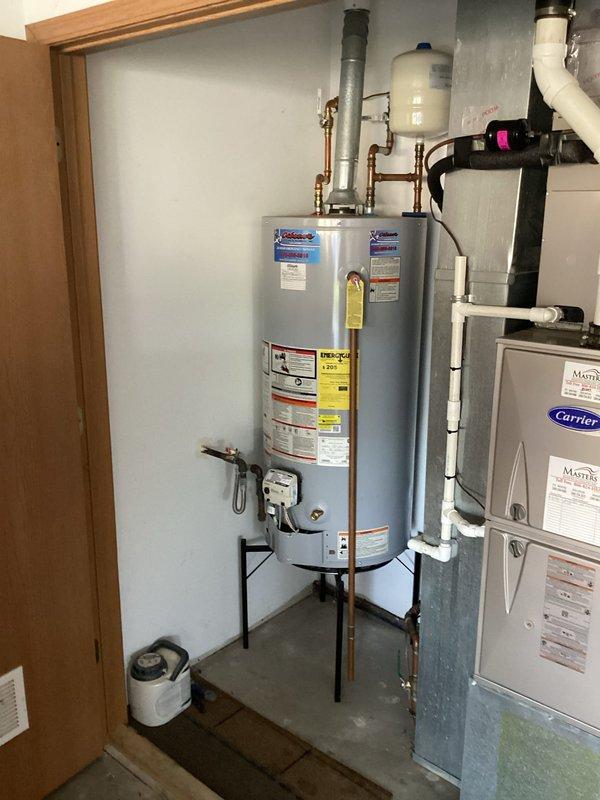 Performed routine maintenance on tanked water heater located in garage mechanical room. Completed full tank flush to remove sediment buildup, tested temperature and pressure relief valve for proper operation, and inspected all copper supply lines and brass fittings for leaks or corrosion. Verified expansion tank pressure and confirmed all safety labels and manufacturer specifications were visible and legible. System is operating within normal parameters.