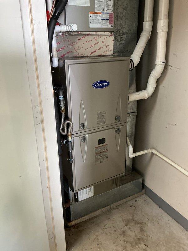 Completed full furnace changeout by removing and recycling existing equipment and installing new Carrier 59TP7A040V17--12 Performance 97 Series two-stage gas furnace with 97% AFUE efficiency rating. Installed Honeywell Vision PRO TH8321R1001 programmable thermostat and reconnected existing supply and return ductwork to new unit. Performed complete electrical wiring connections, verified proper voltage and amperage readings using digital multimeter, and ensured all safety controls functioning correctly. Installed PVC venting system for high-efficiency condensing furnace operation and verified proper drainage. Conducted system startup, adjusted gas pressure, verified temperature rise across heat exchanger, and confirmed two-stage operation cycling properly. Performed post-installation quality assurance walk-through with senior technician to verify installation standards met. Explained thermostat programming and system operation to homeowner, registered equipment warranty with manufacture