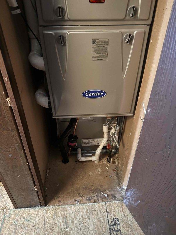 Completed full HVAC system installation including Carrier Comfort Series 26SCA436N003 single-stage air conditioner and Carrier CVAVA4217XMA evaporator coil. Installed outdoor condenser unit on new 2-inch PVC pad with proper gravel base and connected to existing 30-amp electrical circuit. Mounted new electrical disconnect box and whip on exterior wall with conduit running to unit. Indoor evaporator coil installed in utility closet with proper drainage connections and PVC piping configured for condensate removal.

Ran new refrigerant line set between outdoor condenser and indoor coil, ensuring proper insulation and routing through building structure. Completed all refrigerant connections, pressure testing, evacuation, and charging procedures to manufacturer specifications. Verified electrical connections at both indoor and outdoor units for proper voltage and amperage draw.

Installed floor protection in work areas and maintained clean workspace throughout installation. Completed system 